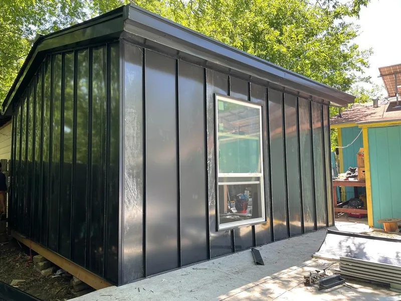 Black standing seam metal wall panels for Roof Inspection in Edinburg