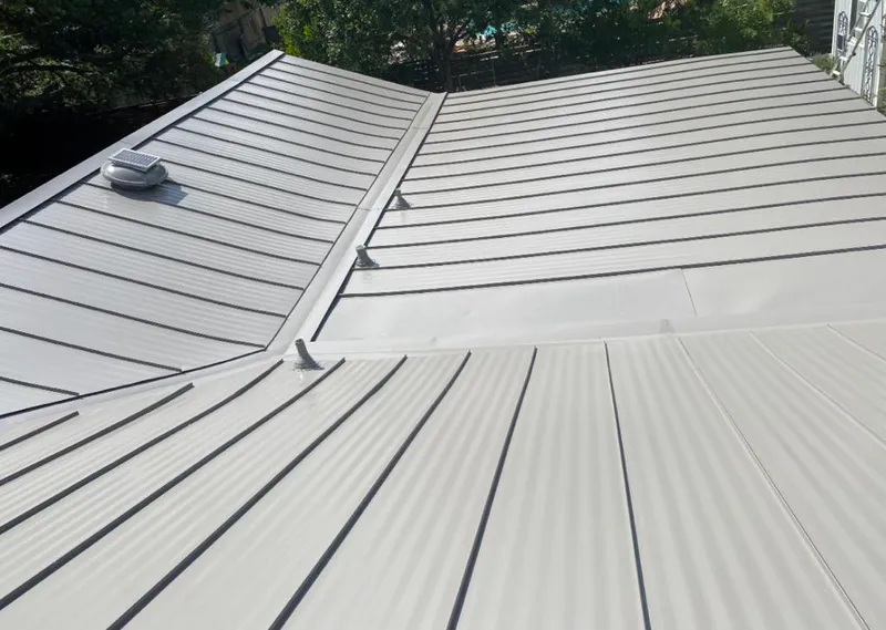Solar attic fan installed on a metal roof for Roof Ventilation in Edinburg